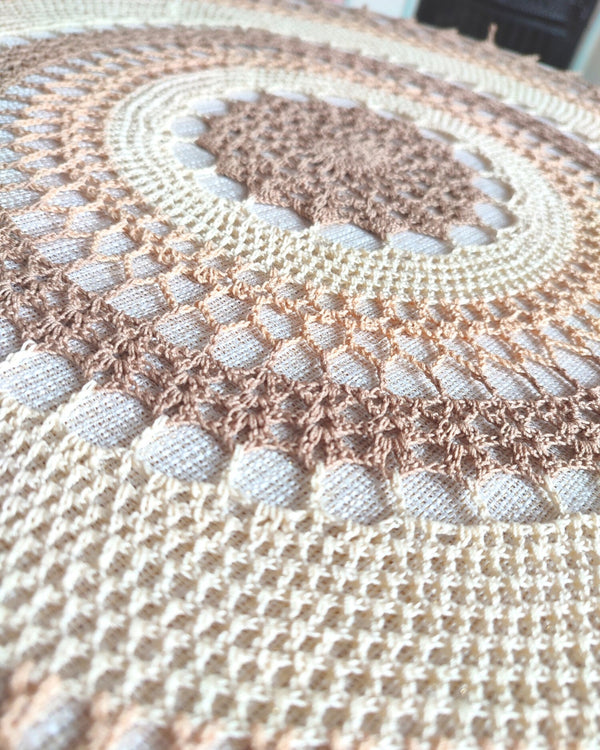 Large multicoloured crochet doily made in shades of natural beige and brown