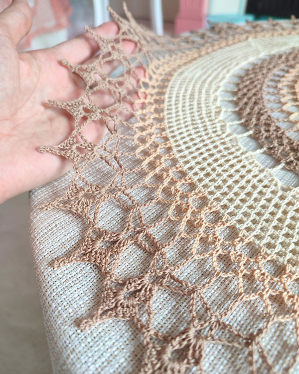 Large multicoloured crochet doily made in shades of natural beige and brown