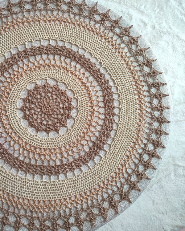 Large multicoloured crochet doily made in shades of natural beige and brown