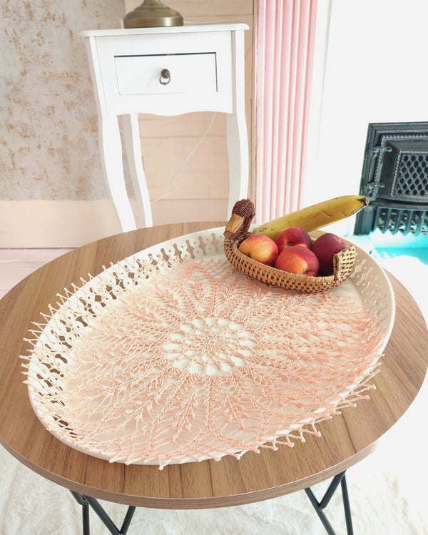Peach colour round lace doily for elegant table or breakfast tray decoration