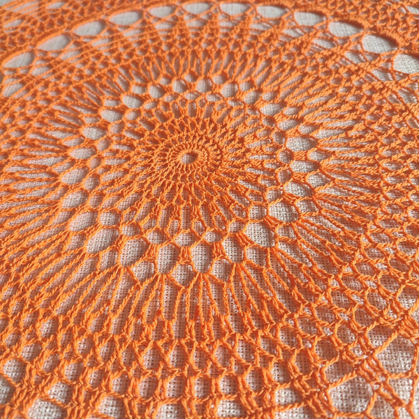 Bright orange large and cheerful lace crochet doily