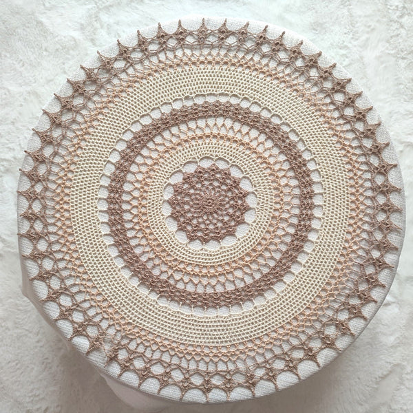 Large multicoloured crochet doily made in shades of natural beige and brown