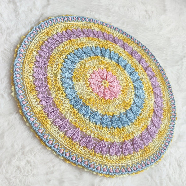 Large colourful yellow doily with pink blue and purple hearts for Easter table decoration