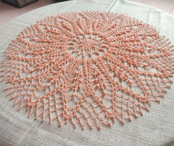 Peach colour round lace doily for elegant table or breakfast tray decoration