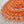 Bright and cheerful round orange crochet doily with a lot of textured 3D elements