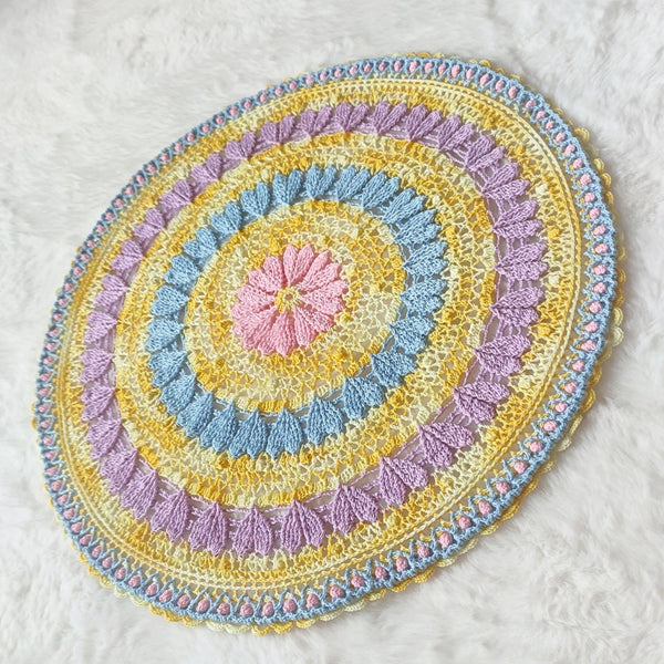 Large colourful yellow doily with pink blue and purple hearts for Easter table decoration