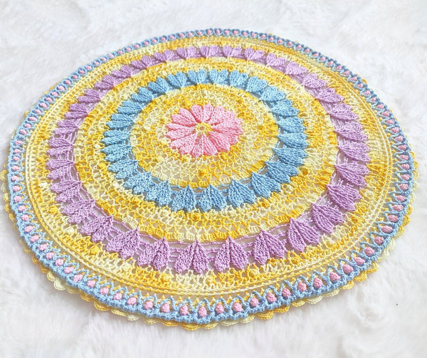 Large colourful yellow doily with pink blue and purple hearts for Easter table decoration