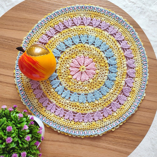 Large colourful yellow doily with pink blue and purple hearts for Easter table decoration